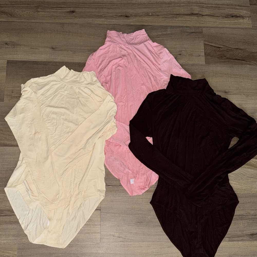 Set of Three Turtleneck Bodysuits in Pink, Cream, and Brown